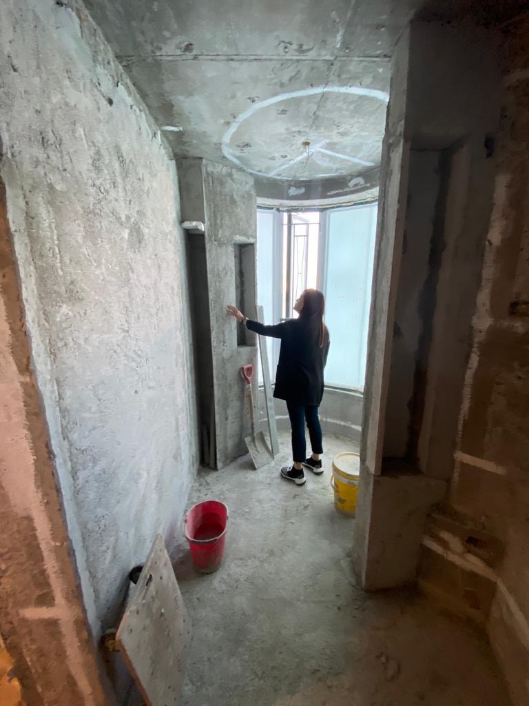 Regina Kwok on a Hong Kong renovation site reviewing progress during the build stage