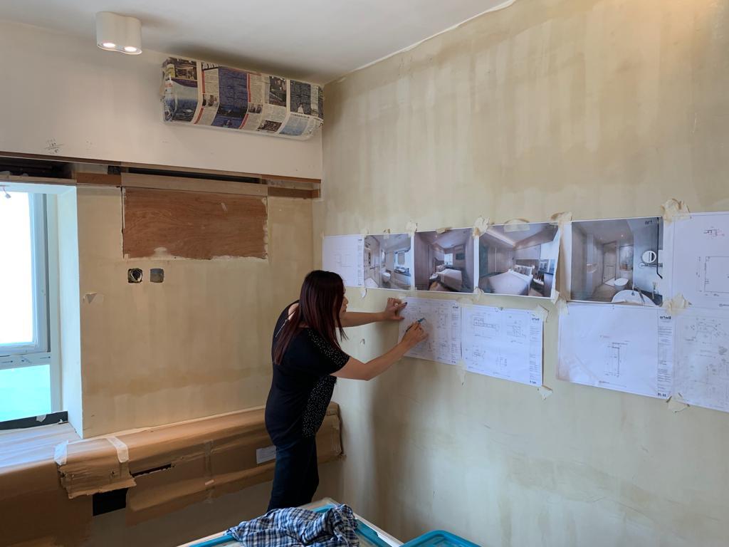 Regina Kwok on site taping out works during a Hong Kong village house renovation