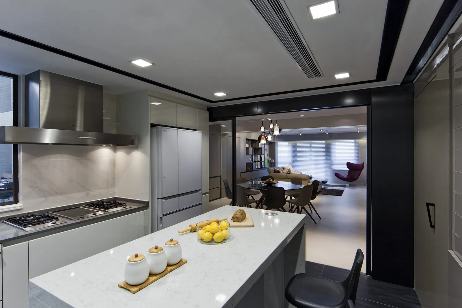 Open kitchen by Artwill with a stone island opening onto the dining and living area, Tin Hau Temple Road, Hong Kong